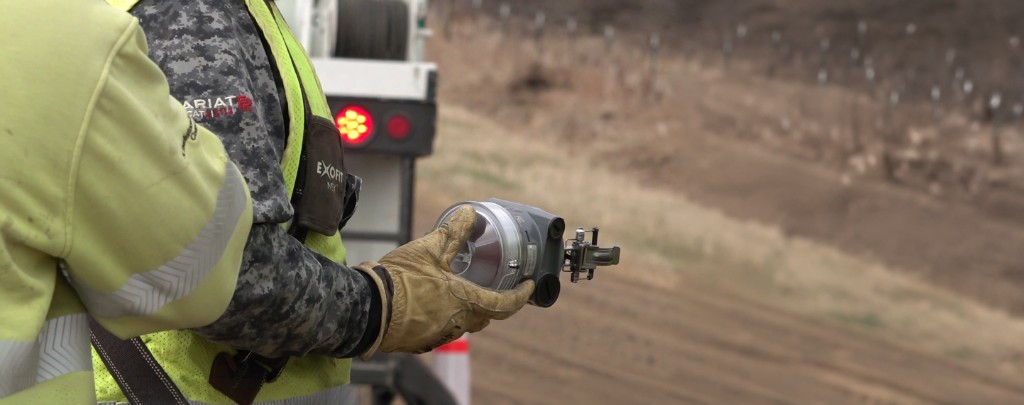 Lineworker holding a Patrolman Plus fault indicator in the field